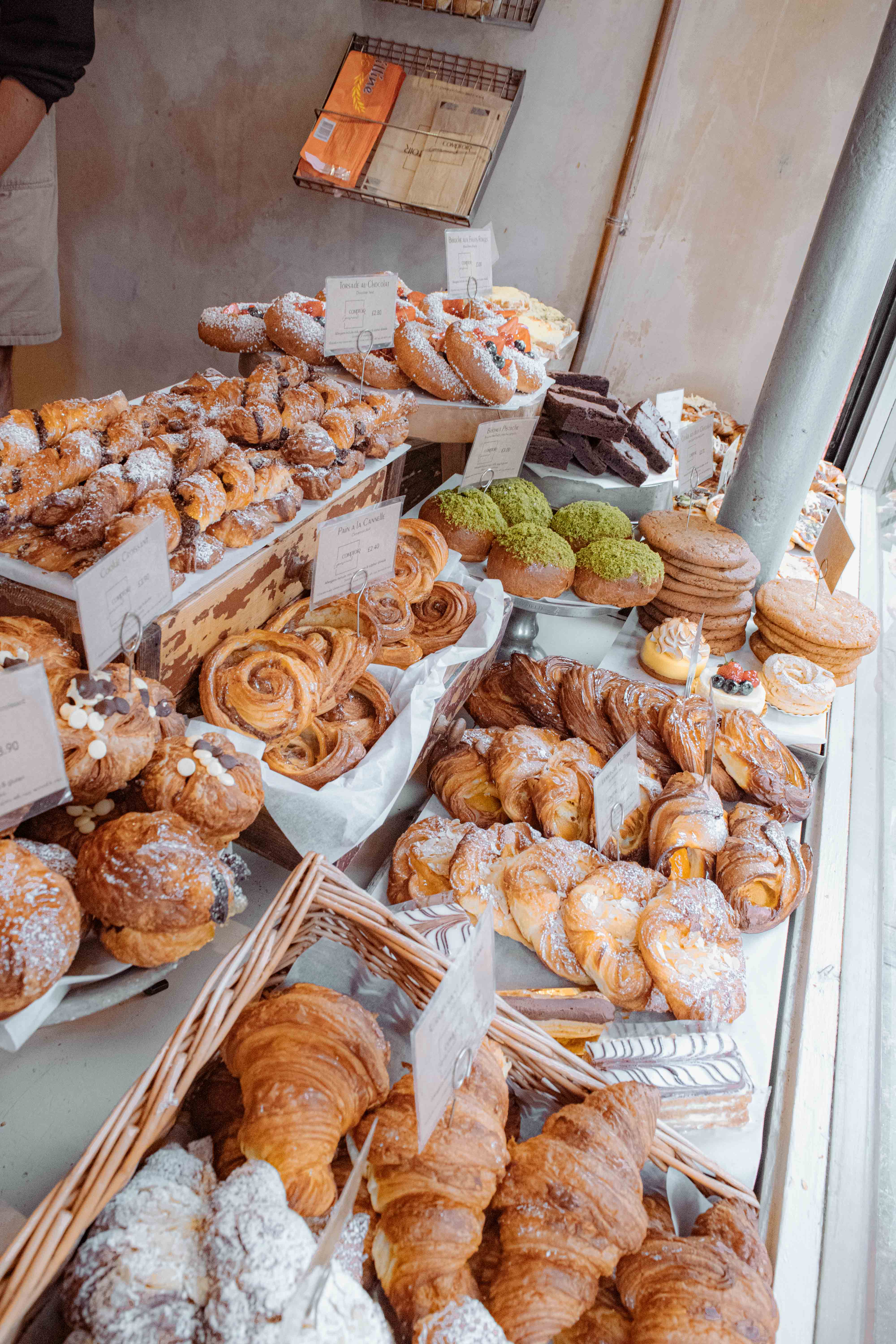 In store main window display of pastries and cookies in the beautiful woven baskets and display trays.